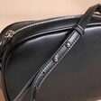 Close up of adjustable strap on Rectangular Crossbody Bag in Black 