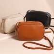 Rectangular Crossbody Bags in Tan, Cream and Black on Beige Surface