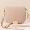 Vegan Leather Crossbody Bag in Pink on top of raised surface against neutral backdrop
