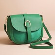 Green Vegan Leather Crossbody Handbag on Beige Background