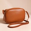 Rectangular Crossbody Bag in Tan in front of neutral backdrop