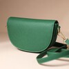 Vegan Leather Half Moon Crossbody Bag in Green on Beige Background 