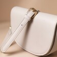 Vegan Leather Half Moon Crossbody Bag in Light Grey with Strap Draped Over Top