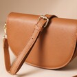 Vegan Leather Half Moon Crossbody Bag in Tan With Strap Draped Over Top