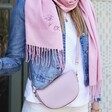 Close Up of Vegan Leather Half Moon Crossbody Bag in Pink on Model