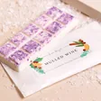Lisa Angel Mulled Wine Soy Wax Melts on top of packaging with beige backdrop and fake snow