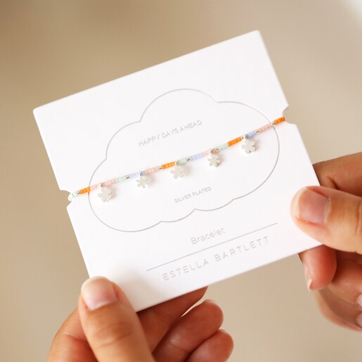 Estella Bartlett Ditsy Flower Miyuki Charm Bracelet In Silver in Packaging in Models Hand