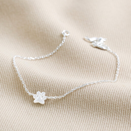 Estella Bartlett Paw Charm Bracelet In Silver on neutral coloured material
