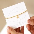 Estella Bartlett Pearl Buttercup Bracelet In Gold in Packaging Held By Model