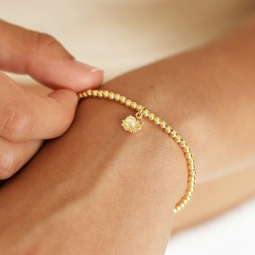 Close Up of Estella Bartlett Pearl Buttercup Bracelet In Gold on Model