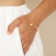 Estella Bartlett Pearl Buttercup Bracelet In Gold on Model's Wrist With Hand in Pocket
