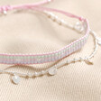 Estella Bartlett Set of 2 Pink and Silver Bracelets on Beige Fabric
