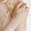 Estella Bartlett Set of 2 Pink and Silver Bracelets on Model holding shoulder