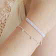 Close Up of Estella Bartlett Set of 2 Pink and Silver Bracelets on model's wrist