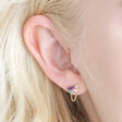 Close up of model wearing the chain stud from the Estella Bartlett Asymmetric Multicolour Crystal Stud Earrings