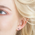 Close up of model wearing the Estella Bartlett Asymmetric Multicolour Crystal Stud Earrings