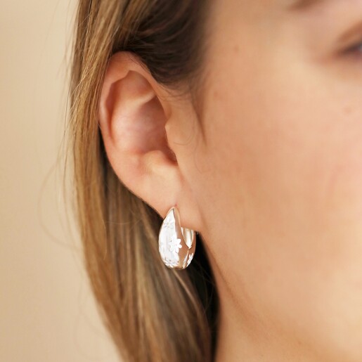 Close Up of Estella Bartlett Chunky Flower Dome Hoops in Silver on Model