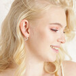 Estella Bartlett Crystal Heart Hoop Earrings in Silver worn by blonde model