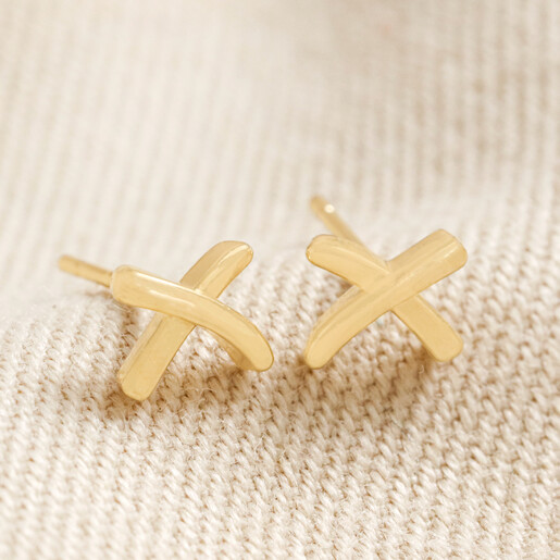 Estella Bartlett Kiss Stud Earrings In Gold on Beige Background