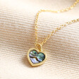 Estella Bartlett Shell Heart Pendant Necklace in Gold on top of beige coloured fabric