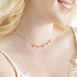 Close Up of Estella Bartlett Ditsy Flower Miyuki Charm Necklace in Gold on Model