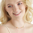 Estella Bartlett Ditsy Flower Miyuki Charm Necklace in Gold on smiling model