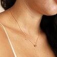 Close Up of Estella Bartlett Knot Pendant Necklace In Gold on Model