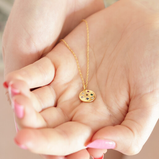 Estella Bartlett Multicoloured Crystal Disc Pendant in Gold Held in Model's Hands