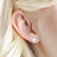 Close up of Sterling Silver Glitter Enamel Star Stud Earrings on model