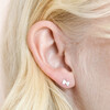 Close Up of Sterling Silver Tiny Bow Stud Earrings on Model