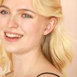 Model laughing Wearing Sterling Silver Tiny Butterfly Stud Earrings
