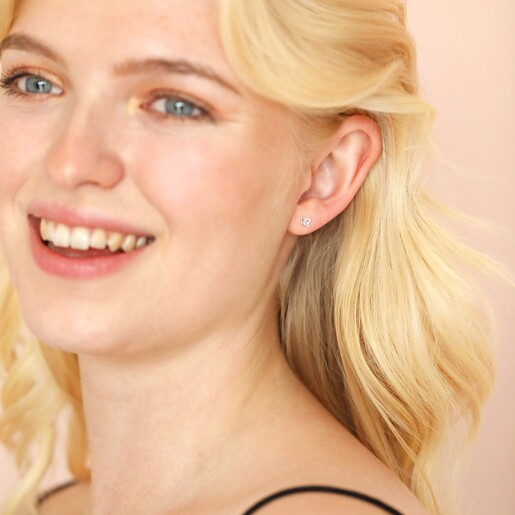 Model laughing Wearing Sterling Silver Tiny Butterfly Stud Earrings