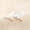 Sterling Silver Dragonfly Stud Earrings on Beige Fabric