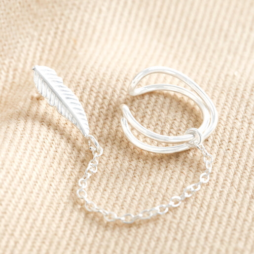 Sterling Silver Feather Stud Cuff and Chain Earring on top of beige coloured material