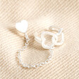 Sterling Silver Heart Stud Cuff and Chain Earring on top of neutral coloured fabric