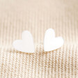 Sterling Silver Heart Stud Earrings on Beige Fabric