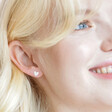 Smiling Model Wearing Sterling Silver Heart Stud Earrings