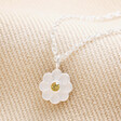 Sterling Silver Enamel Daisy Pendant Necklace on top of beige fabric