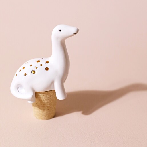 Diplodocus Dinosaur Bottle Stopper on Pink Surface