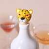 Leopard Head Bottle Stopper in White Bottle with Drinks in the Background