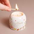 Model lighting Mum Meaningful Word Candle Holder against neutral coloured backdrop