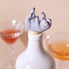 Sloth Bottle Stopper in White Bottle with Drinks in Background