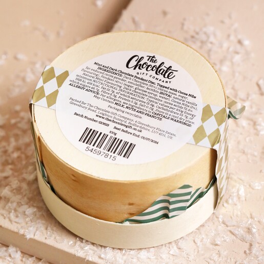 Back of The Chocolate Gift Company Dark Chocolate Mint Fondant Disc Box showing ingredients list on top of beige backdrop