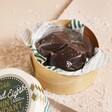 The Chocolate Gift Company Dark Chocolate Mint Fondant Disc Box open showing chocolate fondant discs on top of beige surface with fake snow around