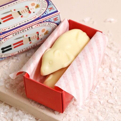The Chocolate Gift Company The Mouse King White Chocolate Mice open showing mice inside on top of beige surface with fake snow