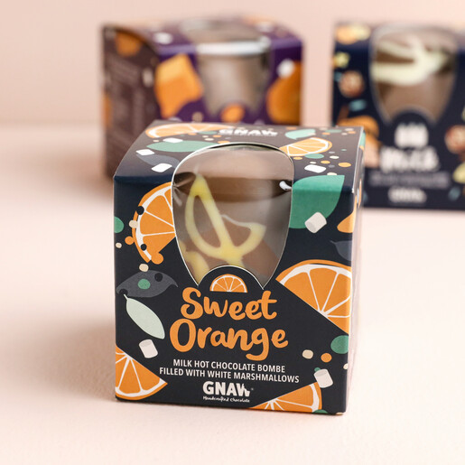 Gnaw Sweet Orange Hot Chocolate Bombe with other hot chocolate bombes in background