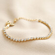 Crystal Tennis Bracelet in Gold on beige fabric