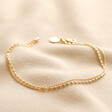 Double Layer Ball Chain Bracelet in Gold on Beige Fabric 