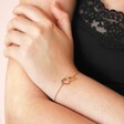 Model Wearing Interlocking Crystal Heart Bracelet in Gold