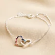 Interlocking Rainbow Crystal Heart Bracelet in Silver on top of beige coloured fabric